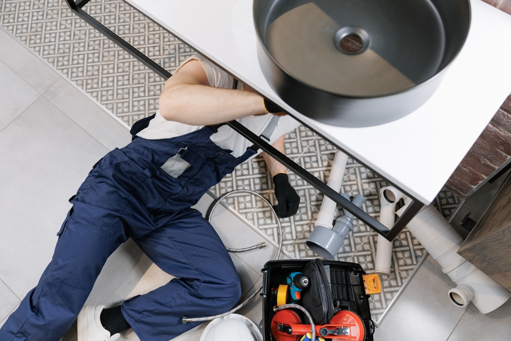 Plumber,Man,At,Work,In,Bathroom,,Fix,Repair,Service,With